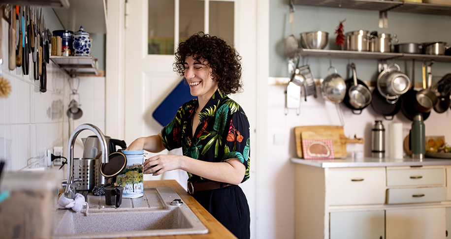 woman laughing in a kitchen